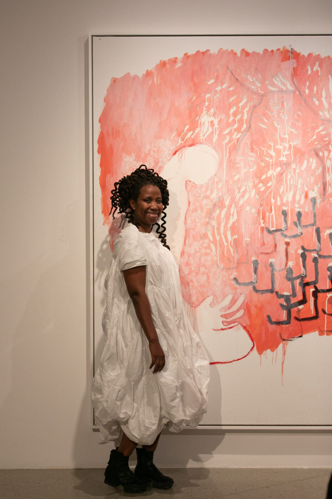 A vertical Portia Zvavahera painting with layered patterns and a central figure from the Tanda rima exhibition.